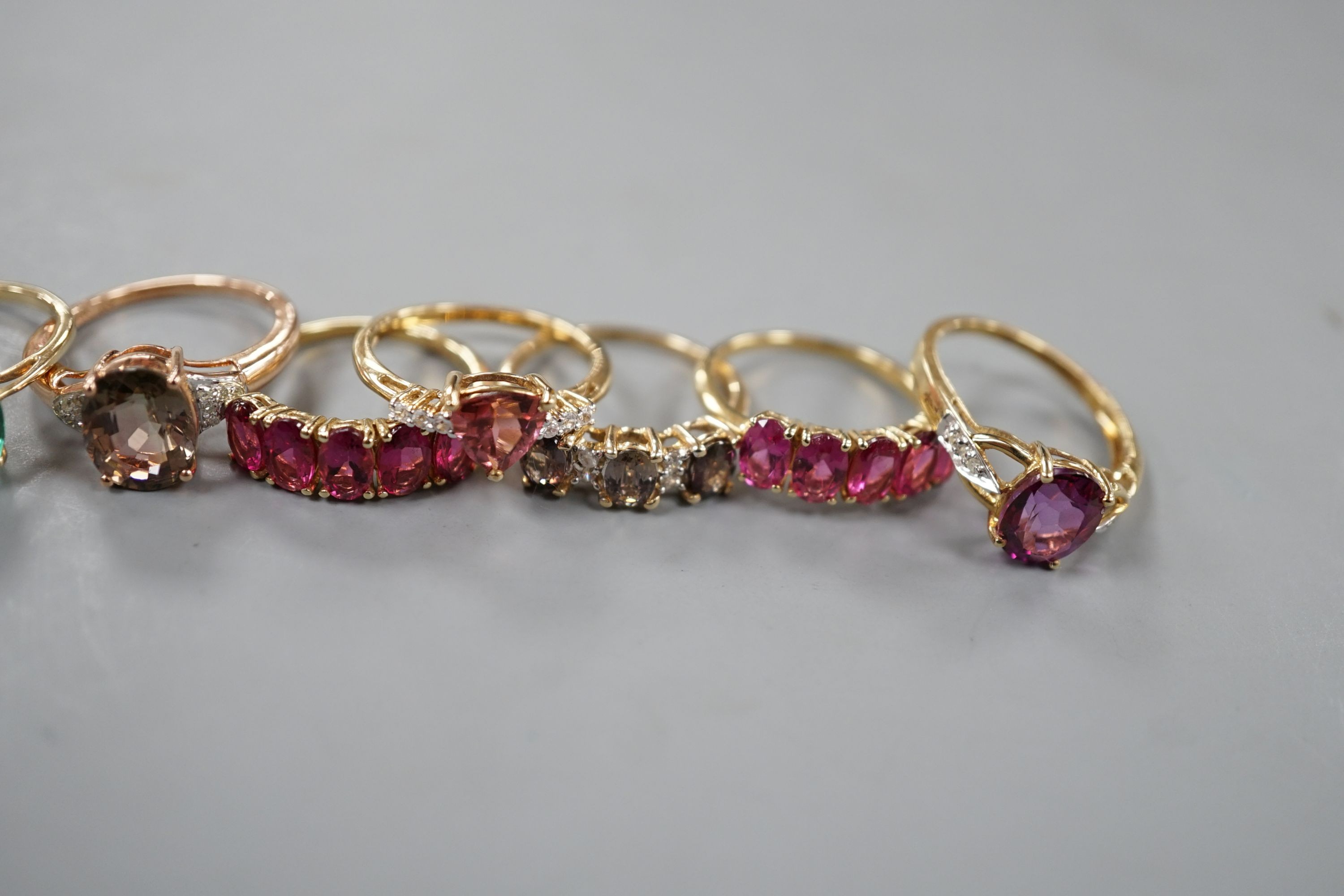 Seven assorted modern 9ct gold and gem set dress rings, including rubellite and a 14ct gold and garnet ring